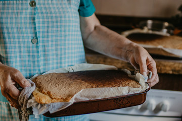 woman's or grandmother's hands with the traditional, homemade cake
