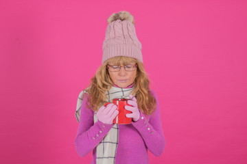 adult woman with cup of coffee or warm infusion isolated on color background