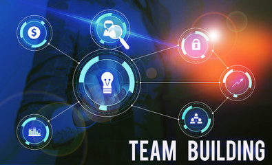 Fototapeta premium Conceptual hand writing showing Team Building. Concept meaning Types of activities used to enhance social relations Woman wear work suit presenting presentation smart device