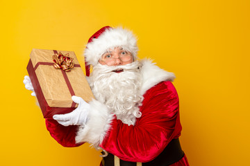 Santa CLaus holding Christmas present
