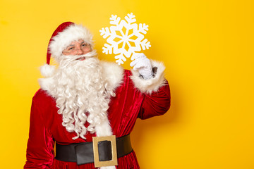 Santa holding a cardboard snowflake