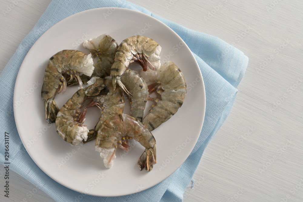 Wall mural raw black tiger prawn shrimps without head, fresh cooking ingredients for a tasty dish, copy space, 