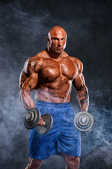 Fototapeta na wymiar Hard Core Bodybuilding. Bodybuilder Lifting Weights