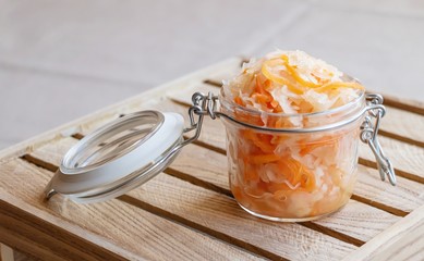 Sauerkraut  with carrots in a glass jar. Is a fermented vegetables. Typical fermented food.