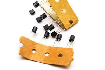 Stack of low power transistors in package TO-92 on a white background