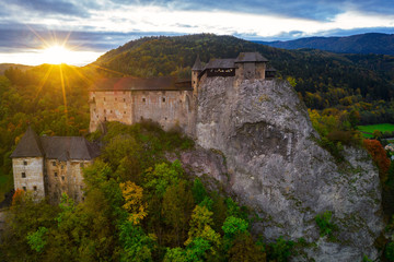 Orava castle - Oravsky Hrad in Oravsky Podzamok in Slovakia. Medieval stronghold. Aerial view during sunset light in autumn