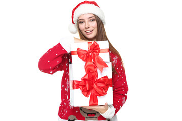Beautiful woman wearing christmas sweater, santa hat and holding gift boxes on white background