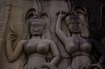 Sculptures on stone temple wall of ancient civilization in Cambodia