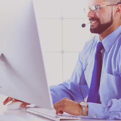 Businessman in the office on the phone with headset, Skype