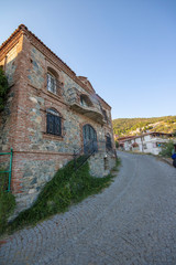Historic old greek houses close-up. There's the sky and the electric cables.