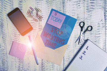 Writing note showing Stop Wasting Time. Business concept for advising demonstrating or group start planning and use it Envelope sheet smartphone notes pen notepad clips scissors wooden back