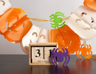 wooden calendar of cubes, garland of pumpkins and spiders