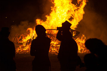 Sillouhette of people, bonfire night, flames from a bonfire, rye, east sussex, uk