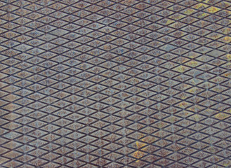 Texture of rusty metal plate with embossed diamond pattern