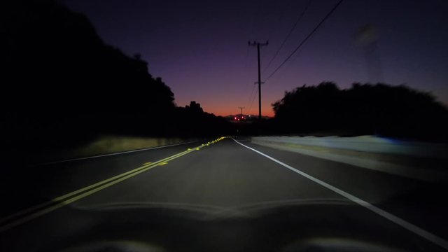 Dawn driving view towards Stoney Point on Santa Susana Pass Road in Los Angeles, California. 