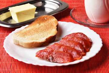Magnificent smoked wild sockeye salmon on a white plate on a bamboo napkin