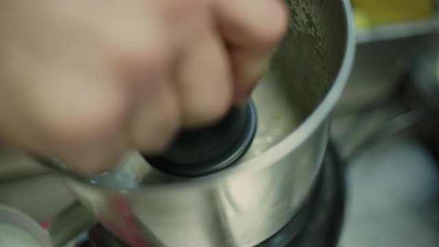 Closeup of cook using a squeezer