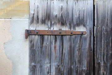 Old rusty hinge on old wooden door