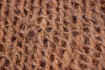 Rough fabric with huge network made from natural raw plant fiber. Detail, closeup. Horizontal. brown tone. Wallpaper and background about manufacture, eco friendly material and textile industry.