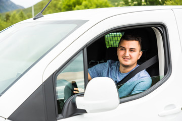 Young handsome man sitting in a car