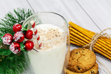 Composition with Christmas cookies and milk on white background