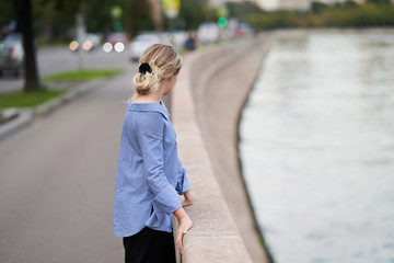 Fototapeta premium Moscow, Russia - August 09, 2019: A girl walks along the embankment of Moscow