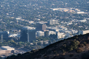 Foggy morning twilight view of the Burbank media district in the San Fernando Valley area of Los Angeles, California.  Shot from hilltop in popular Griffith Park.  