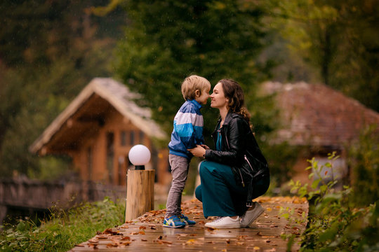 happy family, mother and son outdoors in autumn in the pouring rain, Rosa Khutor, Sochi, October 2019