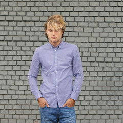 Teenager standing near a brick wall