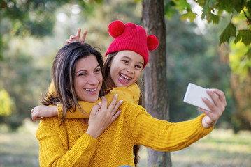 Mother and daughter taking Selfie in the park