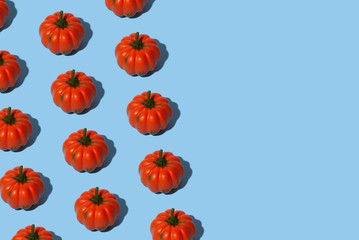 Conceptual halloween pattern with decorative pumpkin on a blue background.