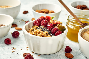 Oatmeal porridge with raspberry and figs in a bowl