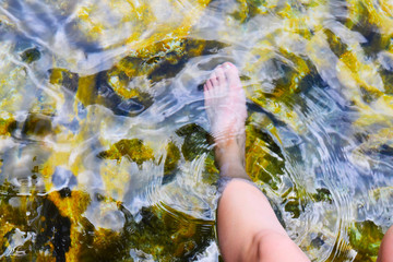 Young woman's foot in the water