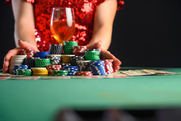 The girl plays cards in the casino and makes an all-in bet. Blackjack. poker. texas poker. gaming...