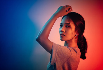 Beautiful woman face. Red and blue light color. Double light colors of potrait.