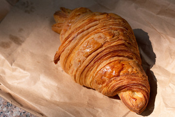 Flakey Croissant on Paper Bag