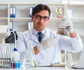 Fototapeta premium Young researcher scientist doing a water test contamination expe