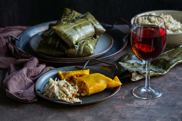 Venezuelan christmas food - hallaca - corn dough stuffed with a stew of pork and chicken and chicken salad, ensalada de gallina