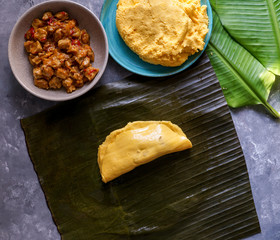 Venezuelan christmas food - hallaca - corn dough stuffed with a stew of pork and chicken and chicken salad, ensalada de gallina