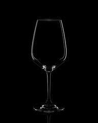 Silhouette of red wine glass on black background