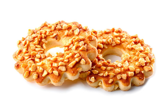 two cookies rings with chopped roasted peanuts close-up isolated on white background