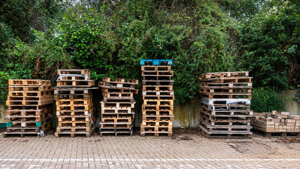 Stacks of wooden pallets in a builders yard