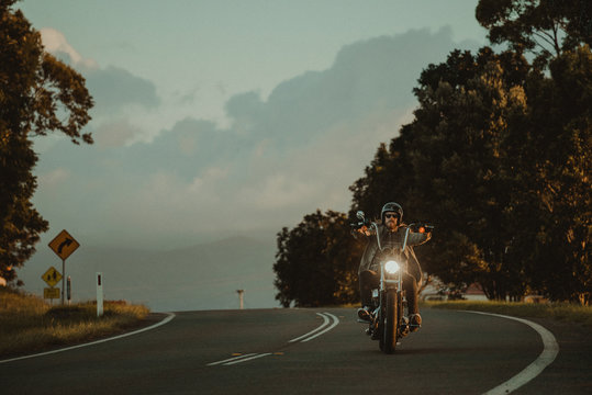 Man Riding His Motorcylce Through A Scenic Landscape