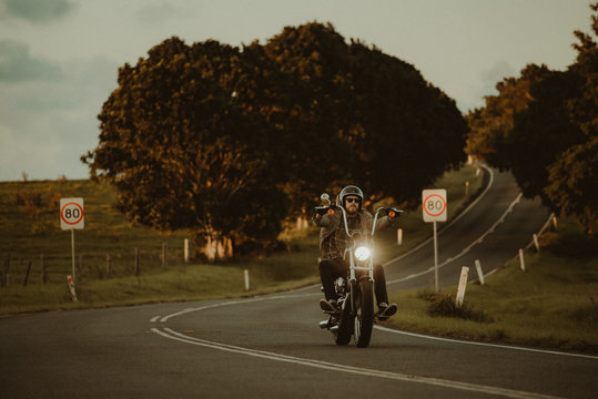 Man Riding His Motorcylce Through A Scenic Landscape