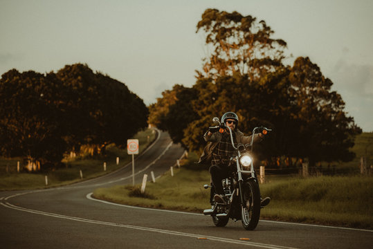 Man Riding His Motorcylce Through A Scenic Landscape