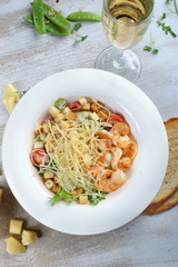 Caesar salad with shrimp on the table
