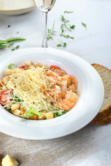 Caesar salad with shrimp on the table