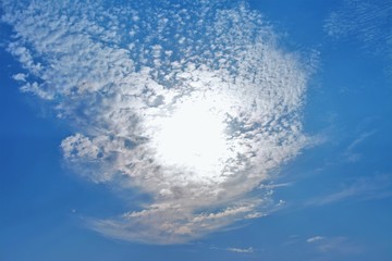 the sun among the white clouds