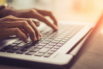 Woman using laptop, searching web, browsing information, having workplace at home.soft focus picture.Vintage concept