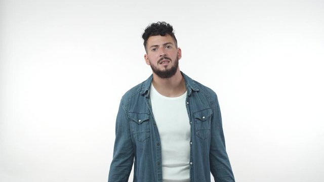 Upset disappointed bearded man face failure, touching head, hands down, exhale troubled, give up or lose, see disappointing news, feel sorrow and uneasy, stand white background, slow motion portrait